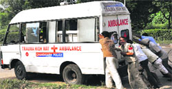The Trauma Highway Ambulance being pushed by passersby and policemen at the Sector 45/46 light point, where a car and a bus collided. Tribune photo: Parvesh Chauhan