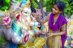 A little street artist giving the finishing touches to an Idol for the forthcoming Ganesh festival in New Delhi on Sunday.