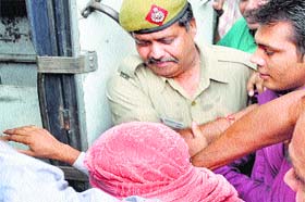 The juvenile involved in the December 16, 2012, gang-rape in Delhi being escorted by policemen