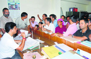 Officials work by candlelight in Mandi on Sunday.