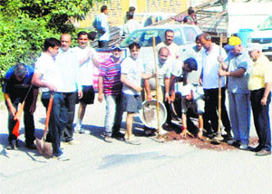 Volunteers of the Rotary Club fill potholes on National Highway-21 in Sundernagar on Sunday