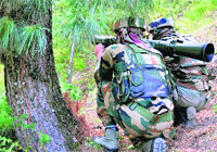 Army men with a rocket launcher during an encounter with militants at Kalaroos forests in Kupwara district of north Kashmir on Sunday. PTI