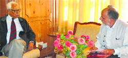 Governor NN Vohra interacts with Ayaz Rasool Nazki, Regional Director, Indian Council for Cultural Relations, in Srinagar on Sunday. A Tribune Photograp