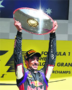Ricciardo hoists the trophy after winning the race. 