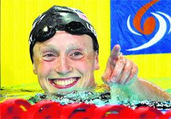 Katie Ledecky of the U.S. points to the crowd after she set a new world record in 1500m freestyle final on Sunday