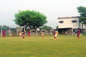 A player heads the ball to the goal during the final match of the Directors Cup Inter School Football Tournament in Dehradun on Sunday