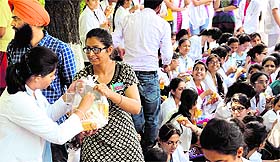 A party activist offers eatables to a protester at Panjab University in Chandigarh on Monday.