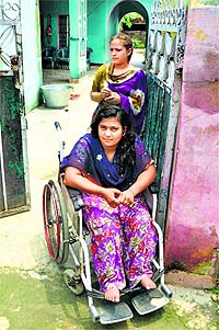 Vijay Kumari on a wheelchair outside her house in Chachwal village in Samba district. 