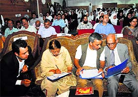 Jury members Mohammad Sayeed Malik, Shahid Rasool and Nusrat Andrabi evaluate the scores of the participants.