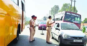 Traffic policemen regulate traffic near Jalandhar Bypass