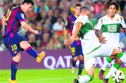 Barcelonas Lionel Messi shoots to score during their Spanish league match against Elche CF at the Camp Nou stadium in Barcelona on Sunday. AFP