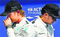 Mercedes drivers Nico Rosberg and Lewis Hamilton walk past each other after the qualifying session at the Belgian Grand Prix in Spa-Francorchamps. Reuters