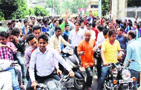 Students take out a scooter rally during a strike in Dehradun on Monday