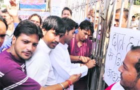 Students lock the gate of DAV College in Dehradun
