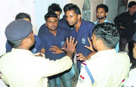 Students argue with policemen in Dehradun on Monday