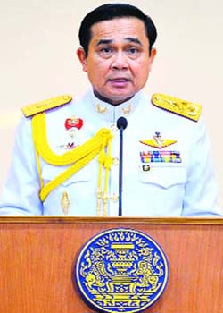 Thai Army Chief Prayut Chan-O-Cha reads a statement after receiving a royal command during a ceremony to swear him in as the PM in Bangkok on Monday