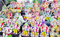 An artist gives final touches to the statues of Lord Ganesha for the coming Ganesh Chaturthi festival in Amritsar on Tuesday