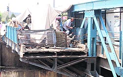 Labourers paint the damaged portion of the Bhandari railway over-bridge in Amritsar on Tuesday