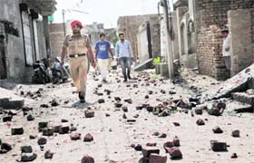 A policeman walks through a street where the violent clash took place in Bathinda on Tuesday