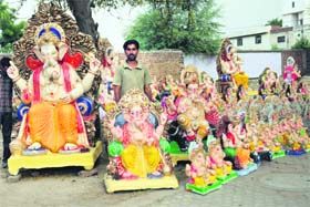 An artisan sells idols of Lord Ganesha on the Bathinda-Goniana road ahead of Ganesh Chaturthi in Bathinda