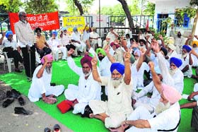 Retired employees protest outside the PRTC workshop at Bathinda bus stand on Tuesday