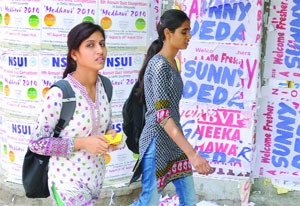 Posters belonging to various students union parties pasted on the Wall of Democracy ahead of forthcoming DUSU election at North Campus in New Delhi on Tuesday. 
