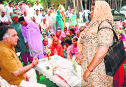 Transport and Technical Education Minister GS Bali listens to grievances of people at Tharu village in Nagrota Bagwan on Tuesday. 