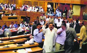 BJP and National Panthers Party legislators raise slogans in the state Assembly on Tuesday against ceasefire violations by Pakistan