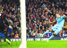 Citys Stevan Jovetic shoots to score the opening goal against Liverpool in their EPL match in Manchester on Monday