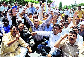 Revenue ameens protest at the Secretariat in Dehradun on Tuesday. 