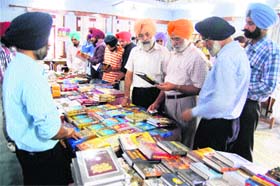 Khalsa College Governing Council honorary secretary Rajinder Mohan Singh along with the college staff at the book fair in Amritsar on Wednesday