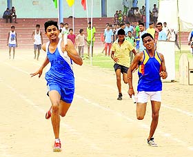 Athletes take part in the 800 metre relay race during the Rural Sports Tournament in Bathinda in Wednesday.