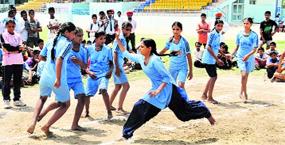 A girl vies for a point in a kabaddi match