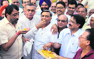 CPS KD Bhandari offers sweets to BJP MLA Manoranjan Kalia at a function held to mark the inauguration of the construction of Chandan Nagar RUB on Wednesday.