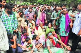 The kin of Harbans Lal, who died in police custody in Khour area, wail in front of the mortuary at Government Medical College and Hospital in Jammu on Wednesday