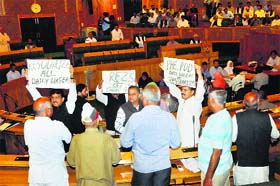 BJP and National Panthers Party MLAs hold placards and raise slogans in the state Assembly in Srinagar on Wednesday against shortage of electricity in Jammu city