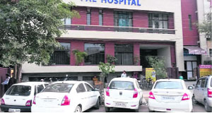 Vehicles parked on a road in front of a private hospital in Ludhiana