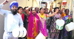 Local residents protest against inadequate water supply in Dehradun on Tuesday. A Tribune photograph