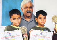 Sports Minister Dinesh Aggarwal felicitates the winners of the Uttarakhand State Chess Championship (under 7 category) in Dehradun on Wednesday. A Tribune photograph