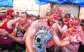 People throw tomatoes at each other during the annual tomatina fiesta in Bunol, Spain, on Wednesday.