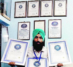 Paper artist Gurpreet Singh with his latest achievements at his residence in Amritsar on Thursday