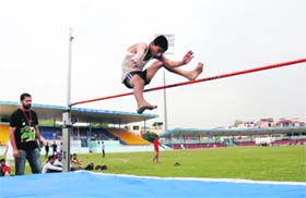 Soaring high: A player takes part in the high jump event during the District Rural Sports Tournament in Bathinda on Thursday