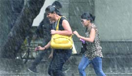 Girls caught in the sudden rain in New Delhi on Thursday.