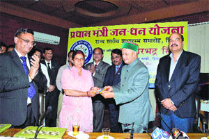 Chief Minister Virbhadra Singh presents a RuPay debit card to a consumer in Shimla on Thursday.