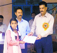 DSP Sanjay Sharma presents a certificate to a girl student on the completion of self-defence training camp in Kullu on Thursday