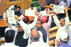 Legislators raise slogans and demand a discussion on price rise in the Assembly on Thursday.