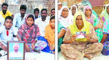 (Right) Balbir Kaur shows the photograph of her son Tarsem Singh who died on August 25 at Rania village; and (left) children of Roop Singh show the photograph of their father who died on August 20 in the same village.