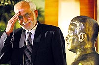 This years Ramon Magsaysay awardee Omara Khan Masoudi of Afghanistan salutes besides a bust of the late Philippine President Ramon Magsaysay at the Ramon Magsaysay Center in Manila on Thursday