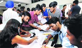 Students of the UIET cross-check their nomination papers on Friday.
