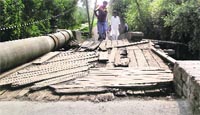 The damaged bridge in the Mir Behri area of Srinagar. Tribune Photo: Amin War